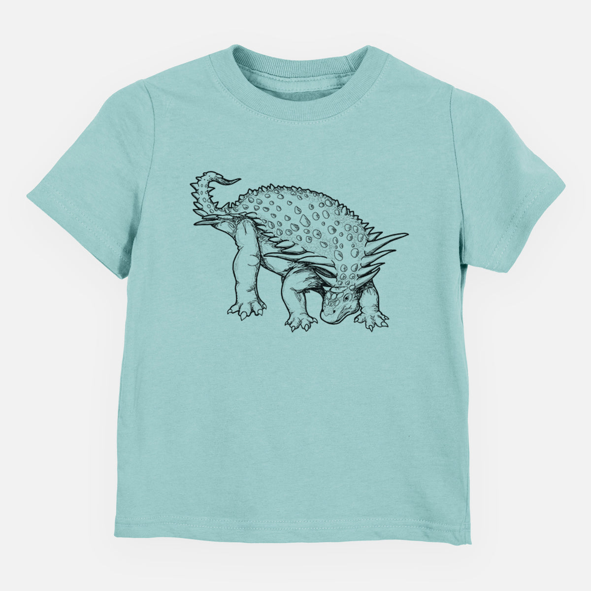 Saltwater toddler t-shirt laid flat, printed with a black ink illustration of an armored Nodosaurus.