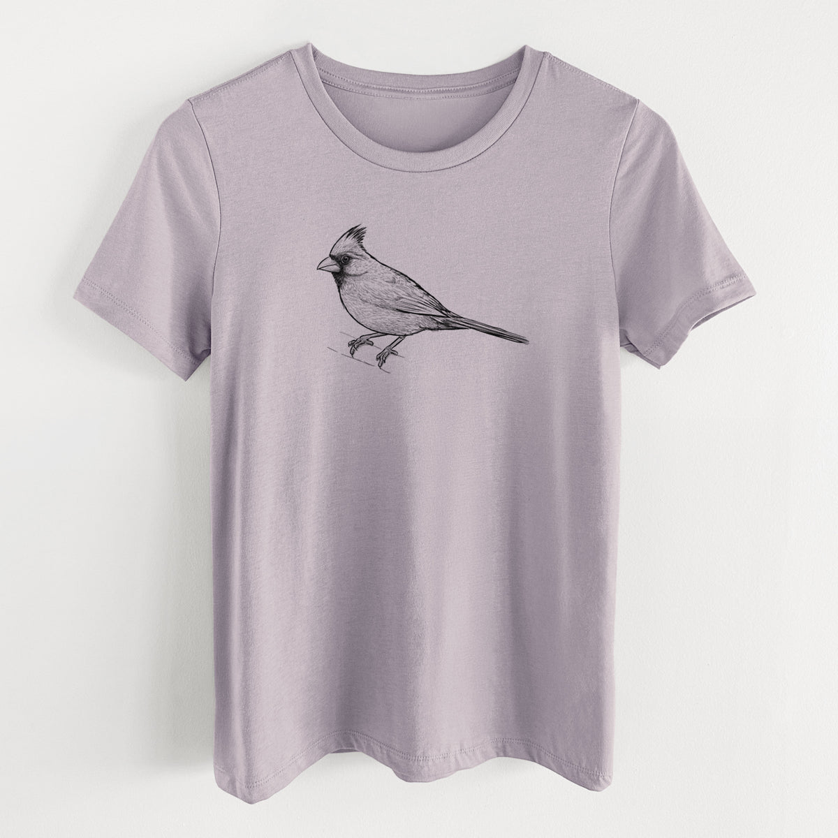 Light violet women's relaxed fit cotton t-shirt laid flat, printed with a detailed black ink sketch of a northern cardinal perched with its crest raised.
