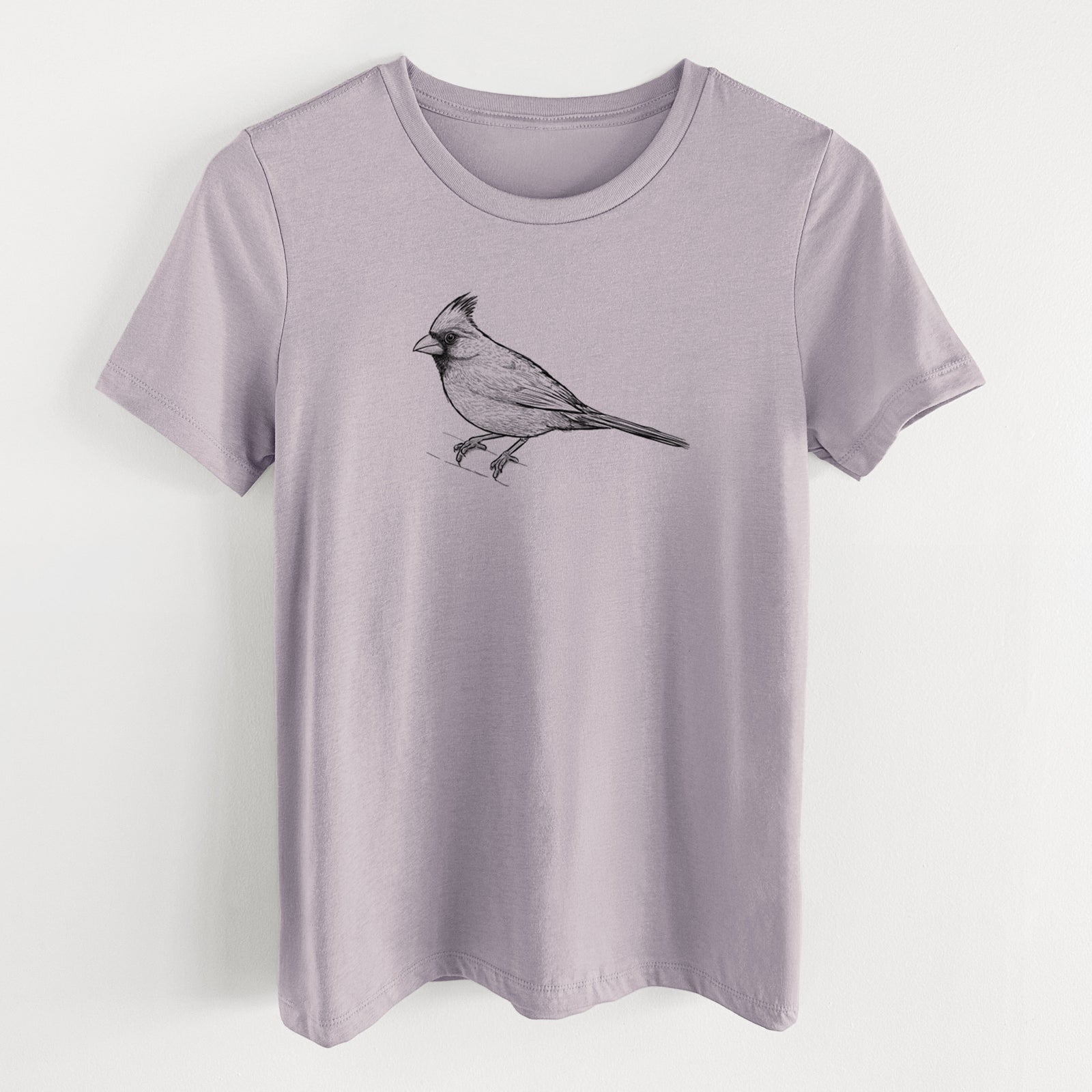 Light violet women's relaxed fit cotton t-shirt laid flat, printed with a detailed black ink sketch of a northern cardinal perched with its crest raised.