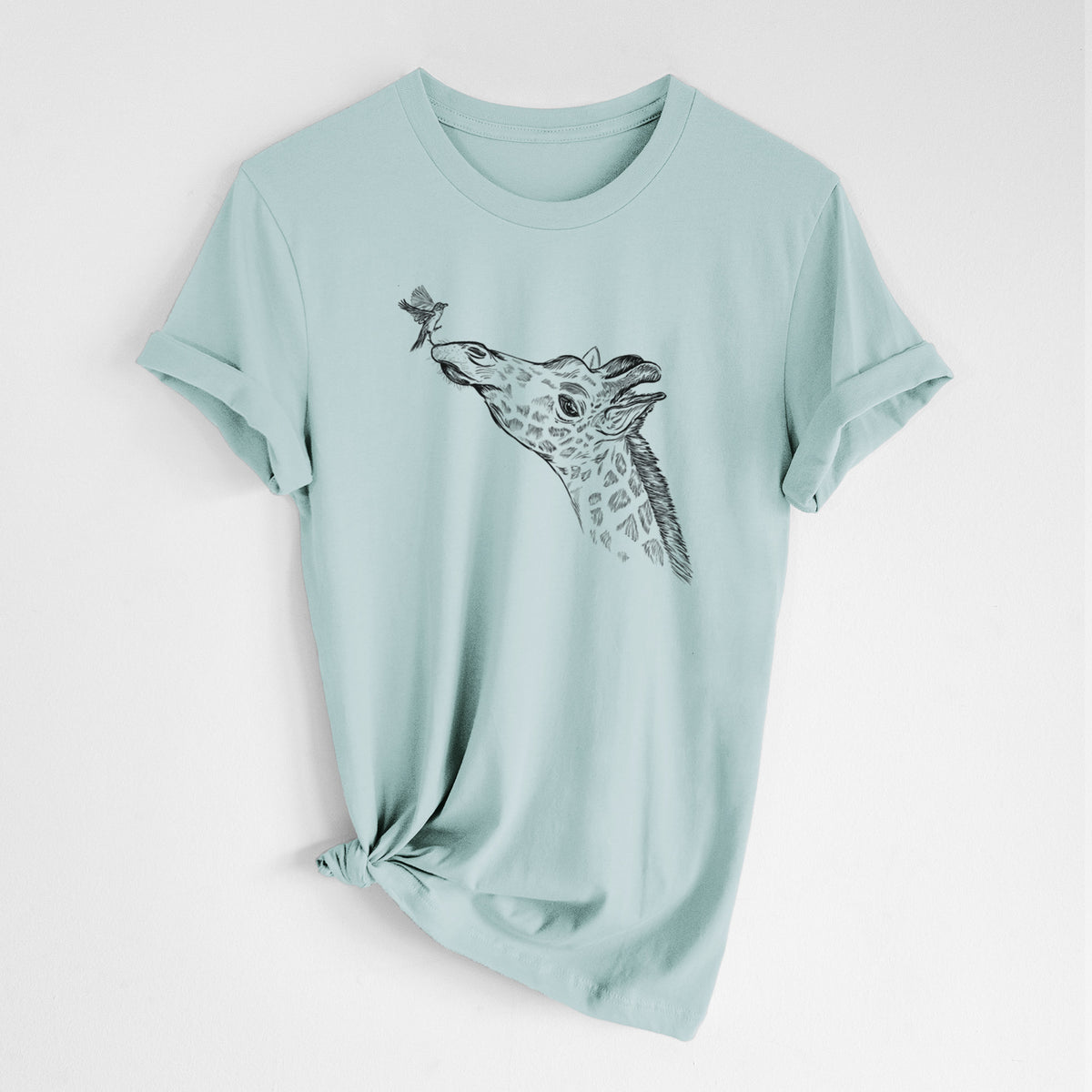 Dusty blue lightweight cotton t-shirt laid flat with the sleeves rolled, printed with a black ink illustration of a northern giraffe reaching its head up to nibble a flower.