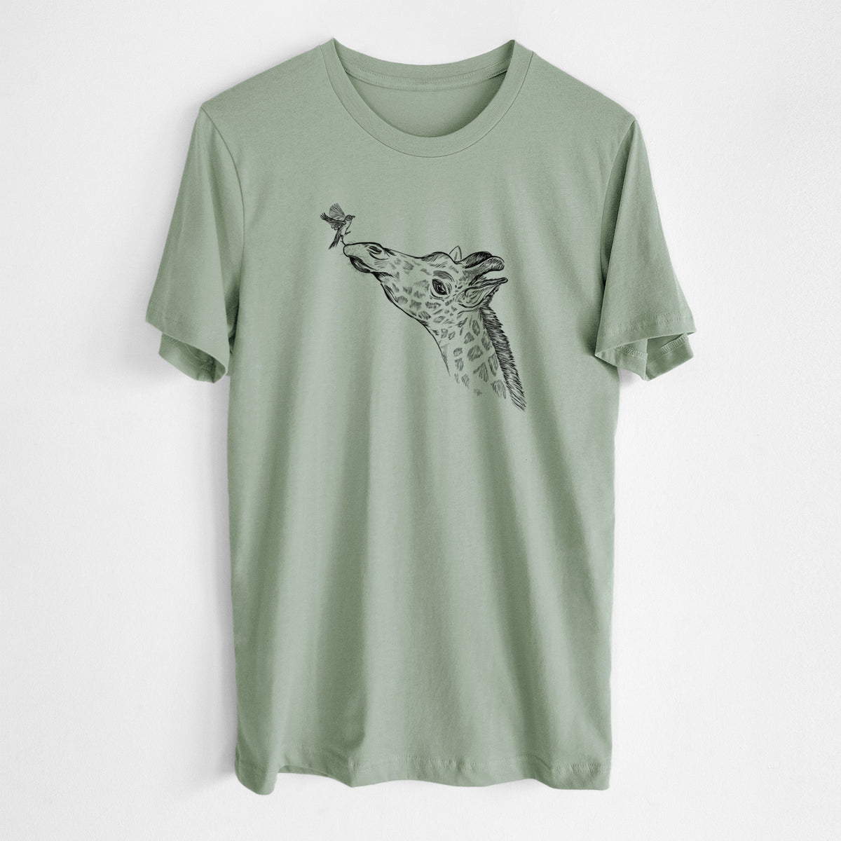 Sage green lightweight cotton t-shirt laid flat, printed with a black ink illustration of a northern giraffe reaching its head up to nibble a flower.