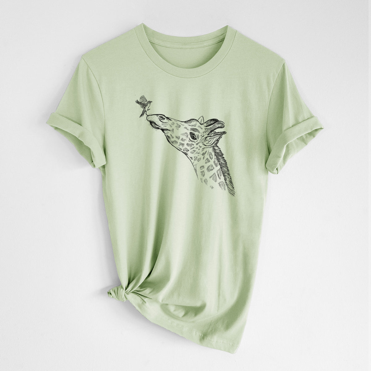 Spring green lightweight cotton t-shirt laid flat with the sleeves rolled, printed with a black ink illustration of a northern giraffe reaching its head up to nibble a flower.