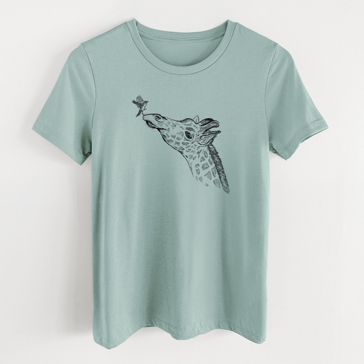 Dusty blue women's relaxed fit cotton t-shirt laid flat, printed with a black ink illustration of a northern giraffe reaching its head up to nibble a flower.