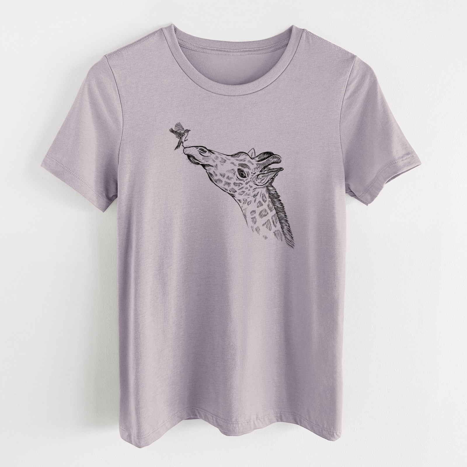 Light violet women's relaxed fit cotton t-shirt laid flat, printed with a black ink illustration of a northern giraffe reaching its head up to nibble a flower.