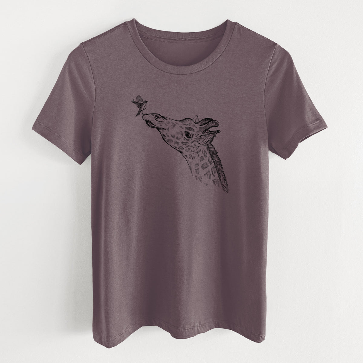 Purple storm women's relaxed fit cotton t-shirt laid flat, printed with a black ink illustration of a northern giraffe reaching its head up to nibble a flower.