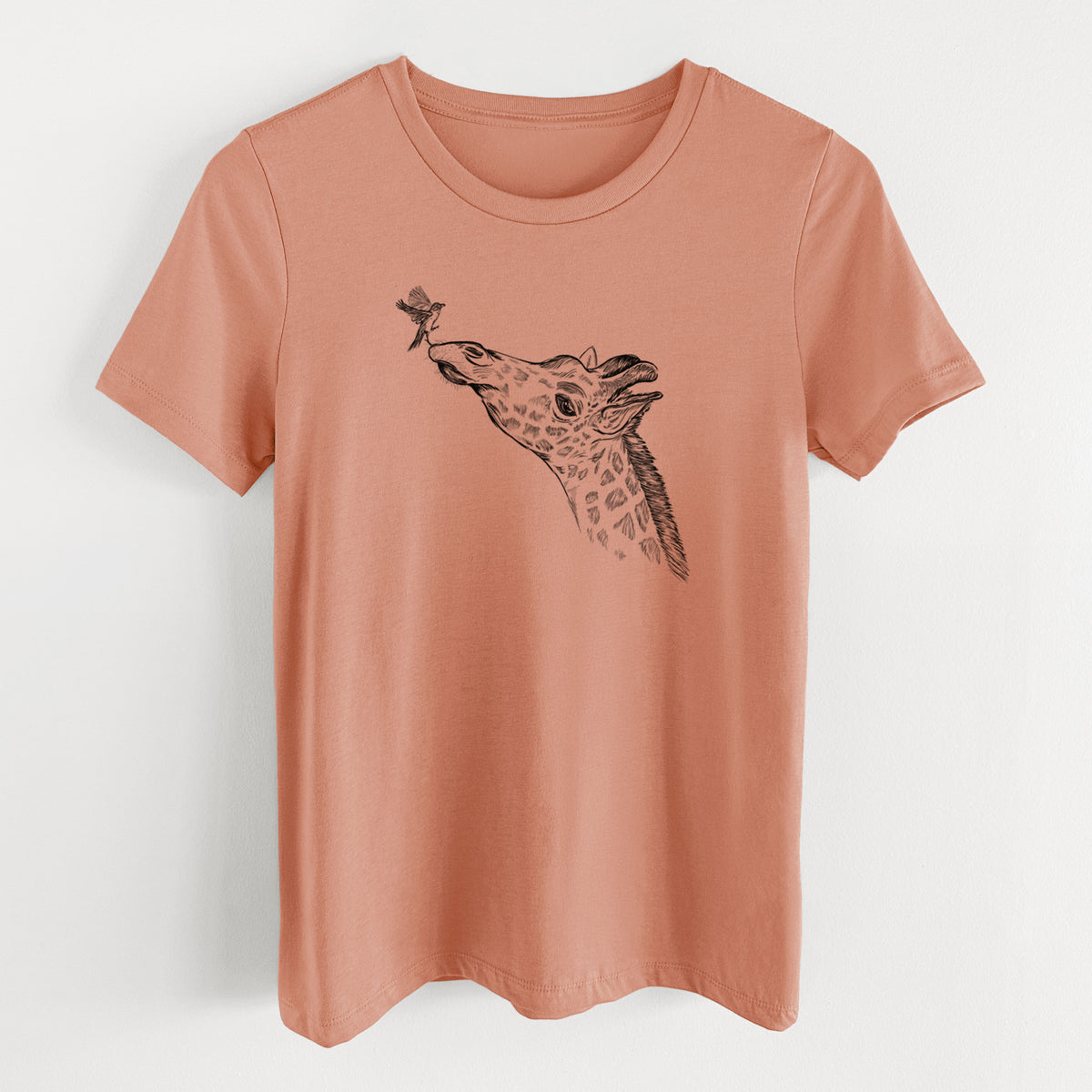 Terracotta orange women's relaxed fit cotton t-shirt laid flat, printed with a black ink illustration of a northern giraffe reaching its head up to nibble a flower.