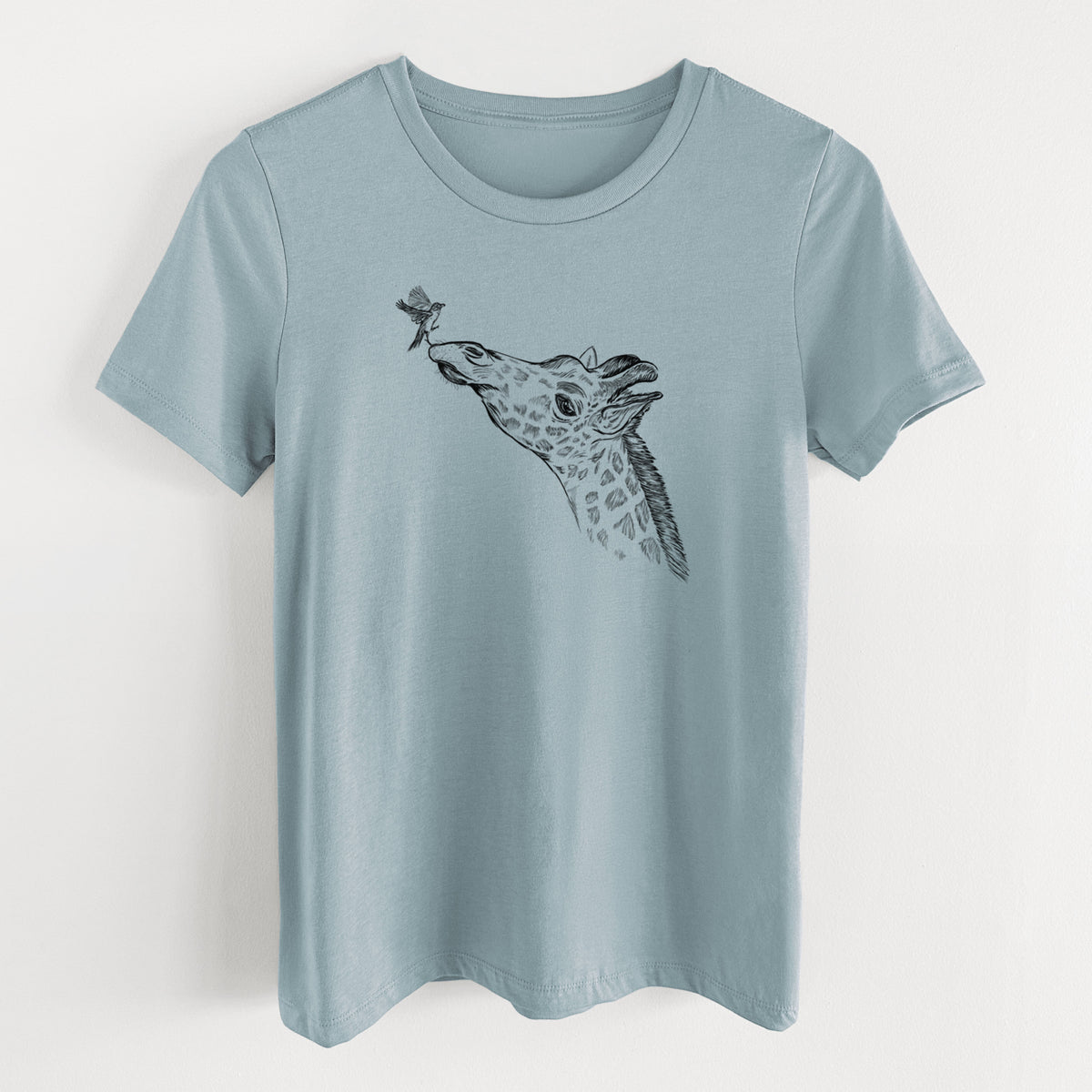 Vintage denim women's relaxed fit cotton t-shirt laid flat, printed with a black ink illustration of a northern giraffe reaching its head up to nibble a flower.