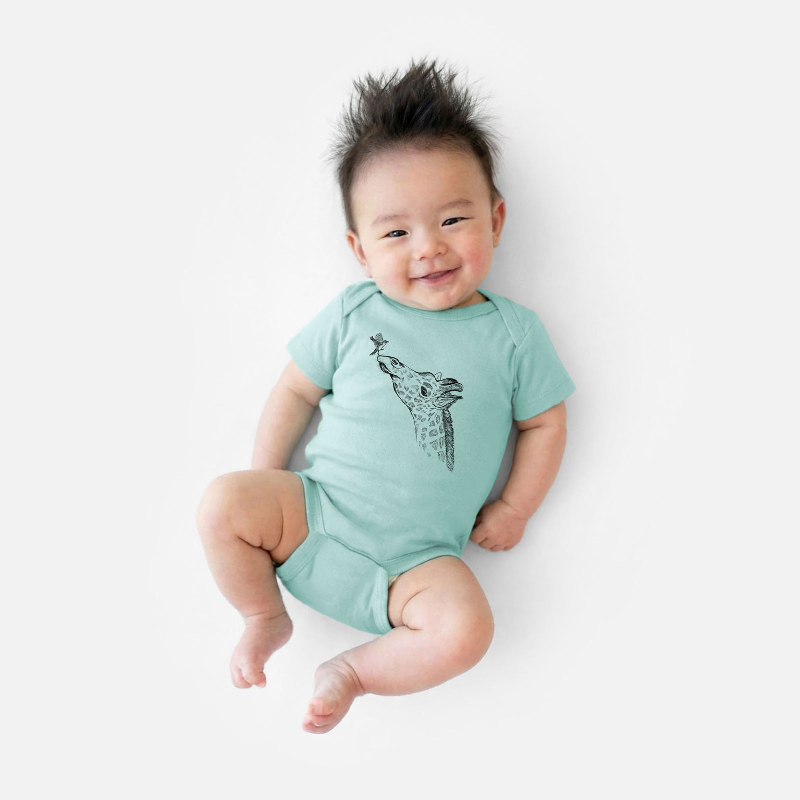 Grey baby bodysuit laid flat, printed with a black ink illustration of a northern giraffe reaching its head up to nibble a flower.