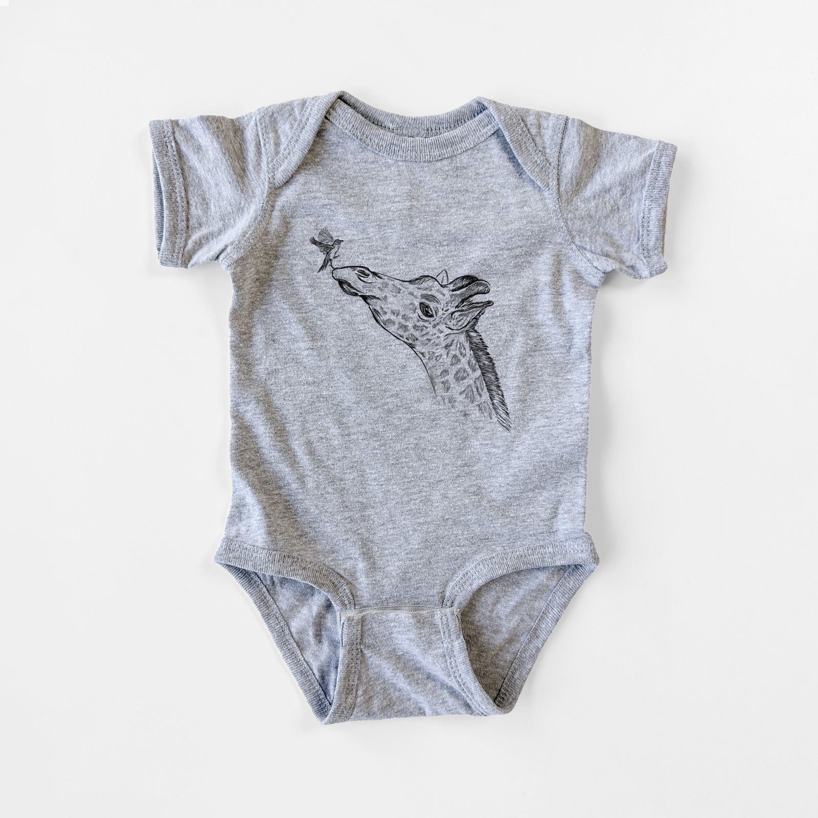 Grey baby bodysuit laid flat, printed with a black ink illustration of a northern giraffe reaching its head up to nibble a flower.
