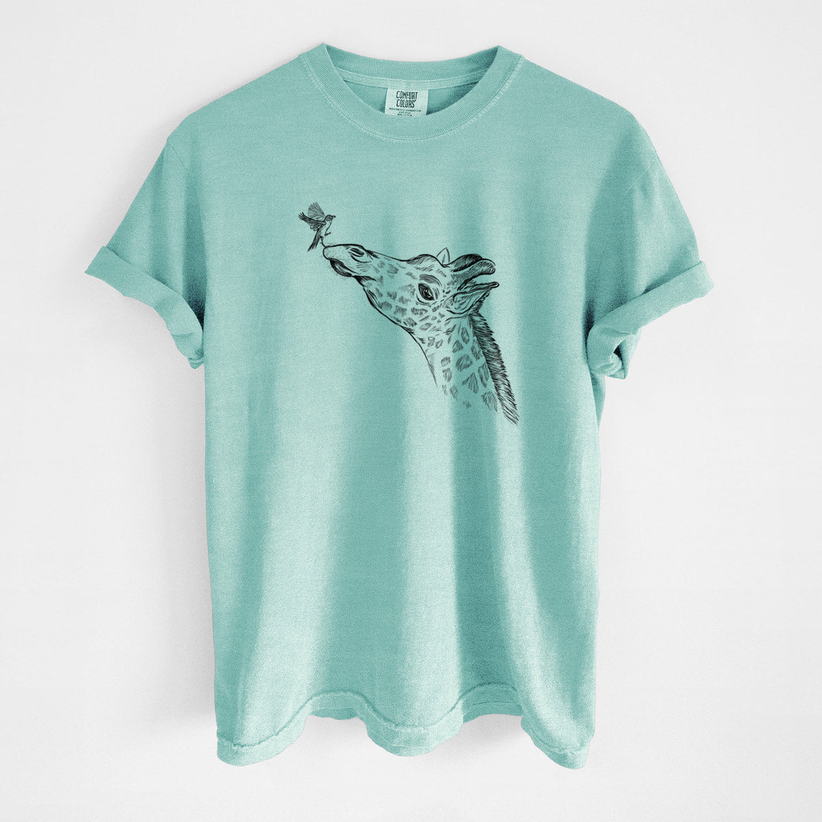 Chalky mint Comfort Colors t-shirt laid flat, printed with a black ink illustration of a northern giraffe reaching its head up to nibble a flower.