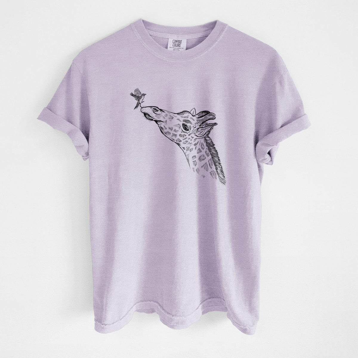 Orchid purple Comfort Colors t-shirt laid flat, printed with a black ink illustration of a northern giraffe reaching its head up to nibble a flower.