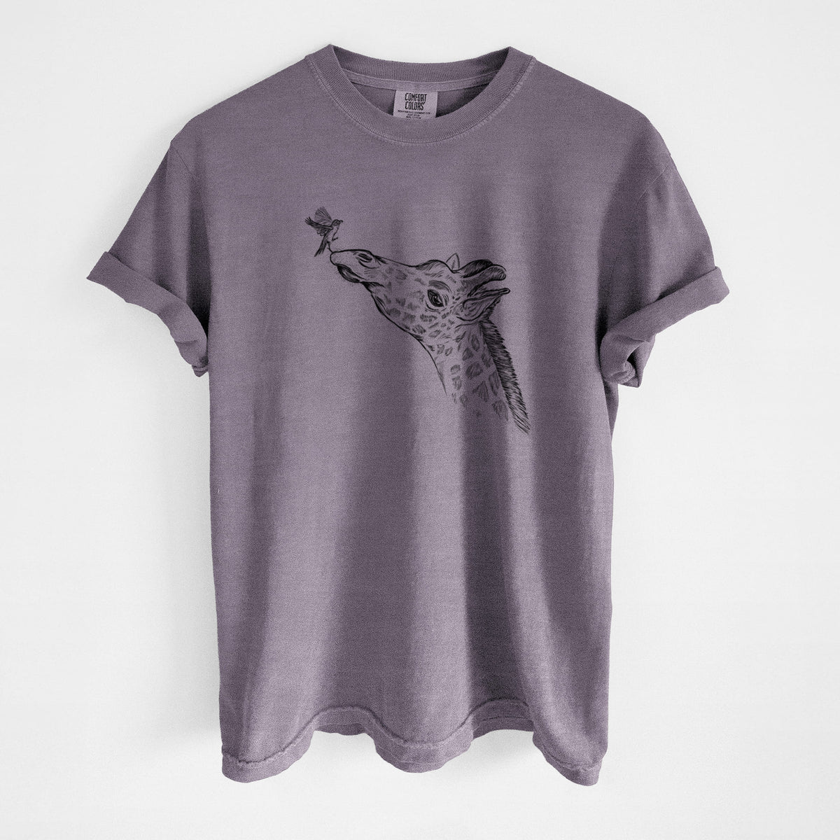 Wine red Comfort Colors t-shirt laid flat, printed with a black ink illustration of a northern giraffe reaching its head up to nibble a flower.