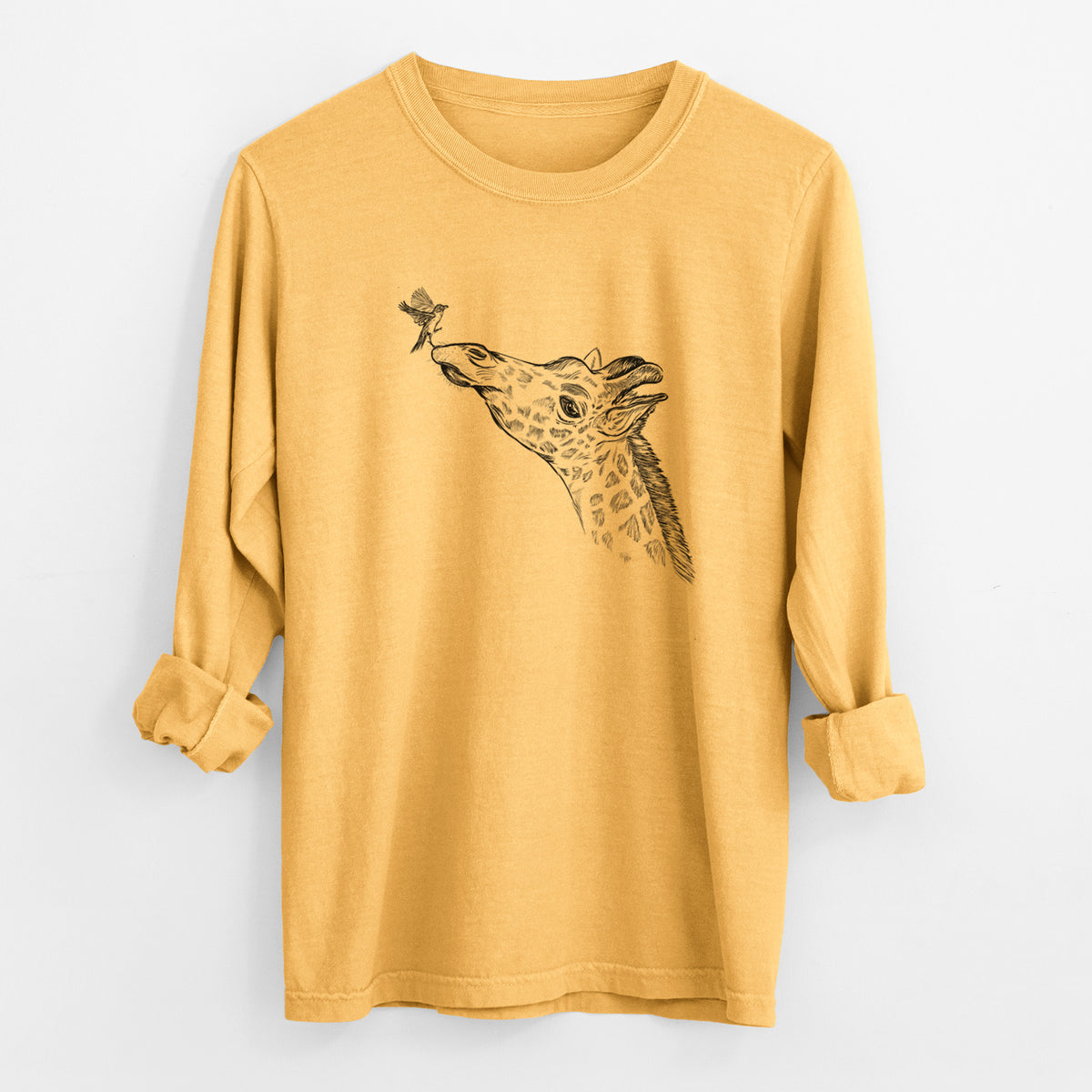 Golden wheat yellow Comfort Colors long sleeve shirt laid flat with the cuffs rolled, printed with a black ink illustration of a northern giraffe reaching its head up to nibble a flower.