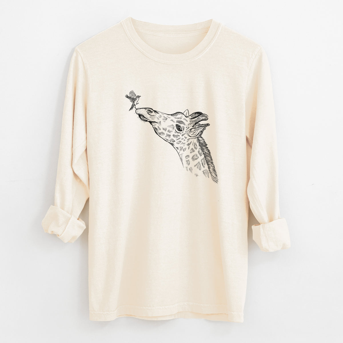 Ivory Comfort Colors long sleeve shirt laid flat with the cuffs rolled, printed with a black ink illustration of a northern giraffe reaching its head up to nibble a flower.