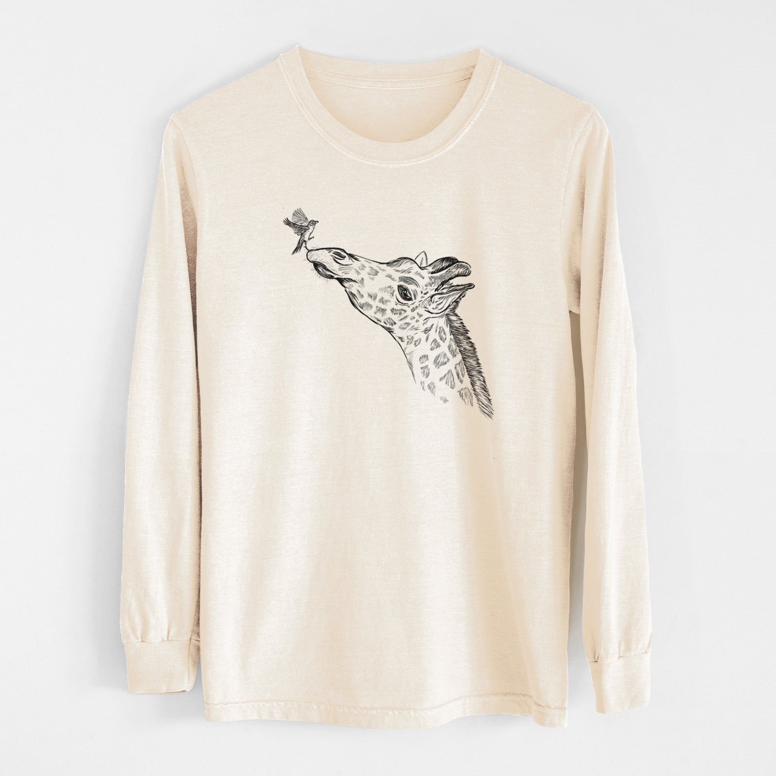 Ivory Comfort Colors long sleeve shirt laid flat, printed with a black ink illustration of a northern giraffe reaching its head up to nibble a flower.
