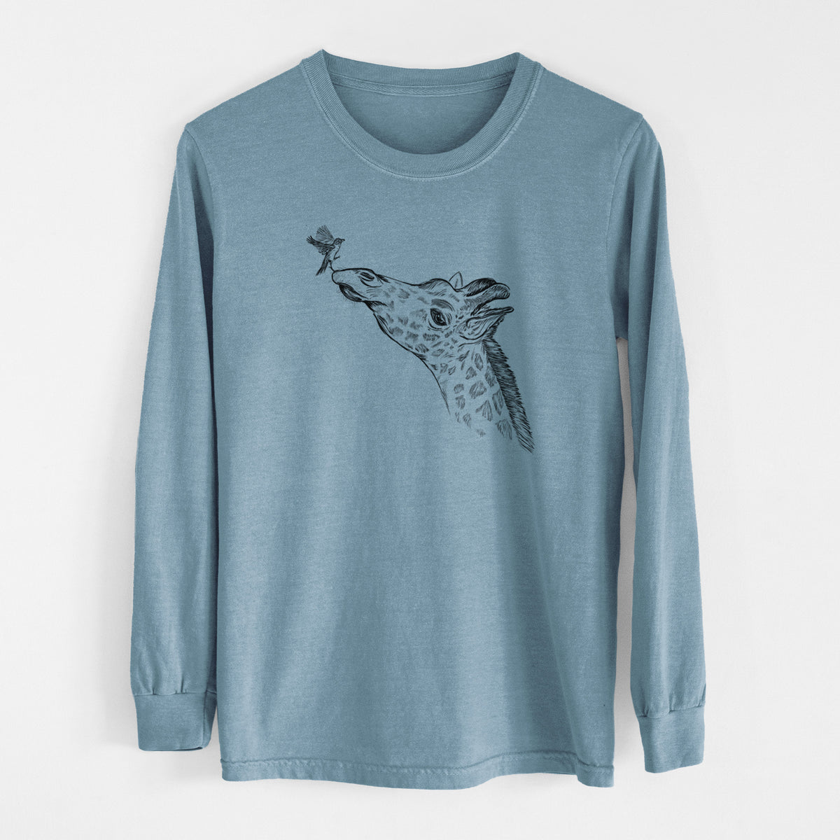 Steel blue Comfort Colors long sleeve shirt laid flat, printed with a black ink illustration of a northern giraffe reaching its head up to nibble a flower.