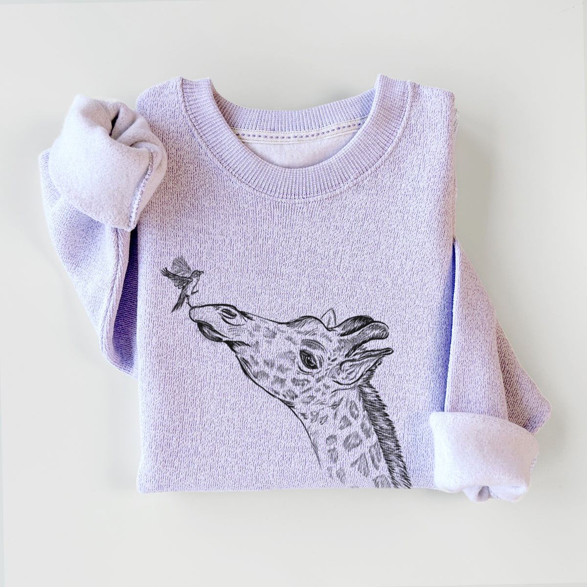 Ice purple knit sweatshirt printed with a black ink illustration of a northern giraffe reaching its head up to nibble a flower, styled flat.