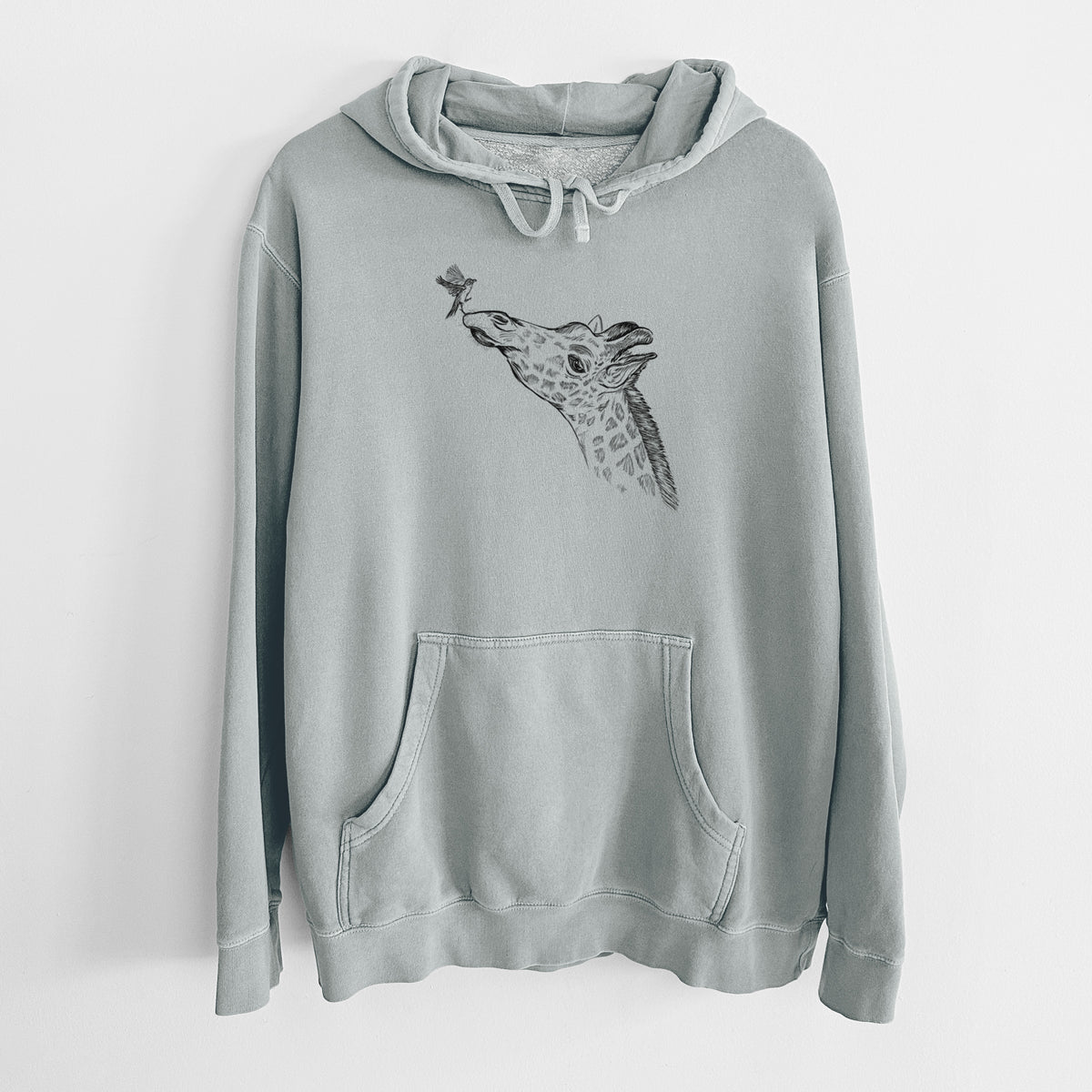 Sage green pigment dyed hoodie laid flat, printed with a black ink illustration of a northern giraffe reaching its head up to nibble a flower.