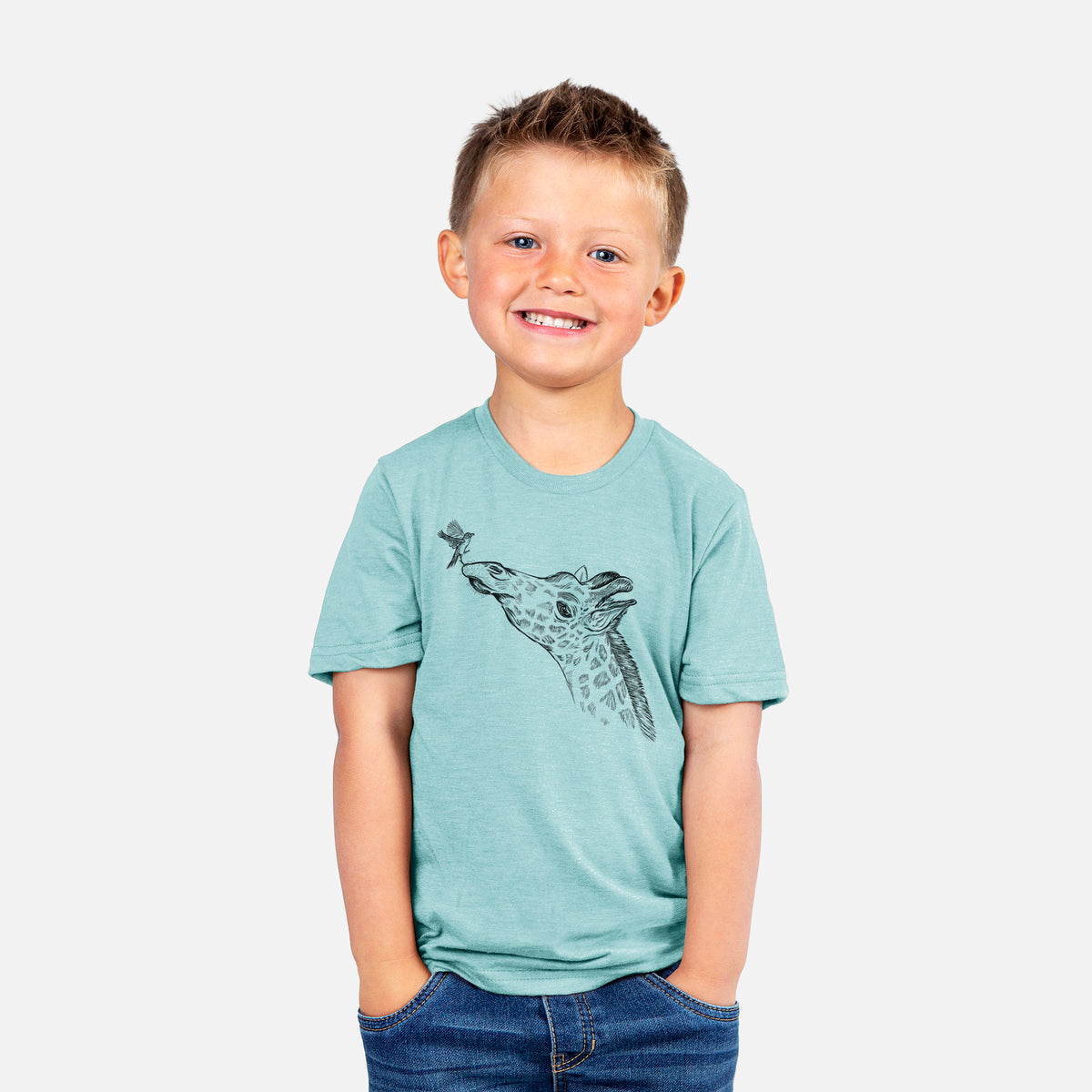 Smiling boy wearing a youth t-shirt printed with a black ink illustration of a northern giraffe reaching its head up to nibble a flower.