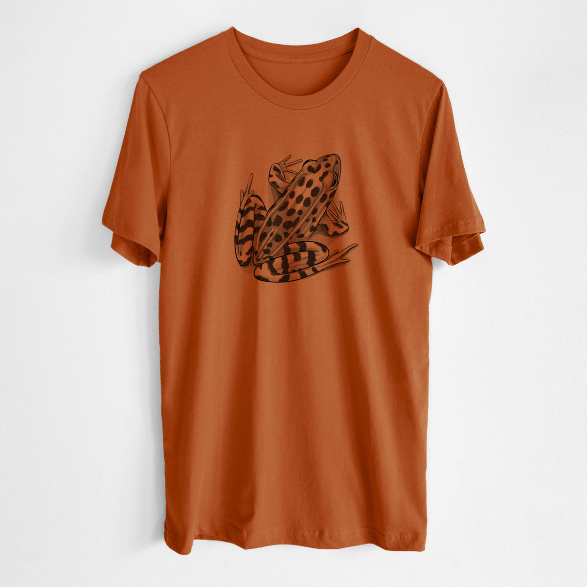 Autumn lightweight cotton t-shirt laid flat, printed with a detailed black ink illustration of a spotted northern leopard frog.