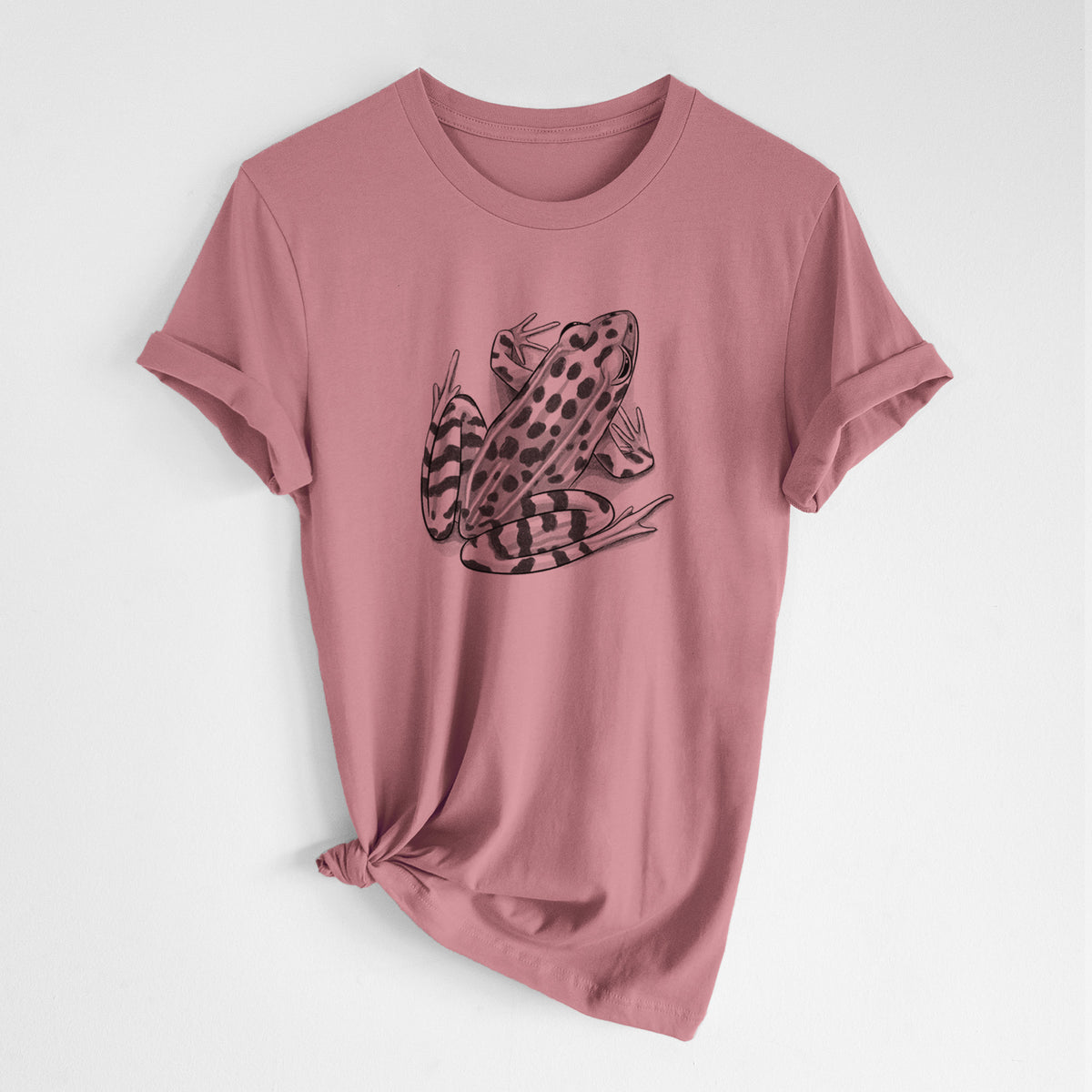 Mauve pink lightweight cotton t-shirt laid flat with the sleeves rolled, printed with a detailed black ink illustration of a spotted northern leopard frog.