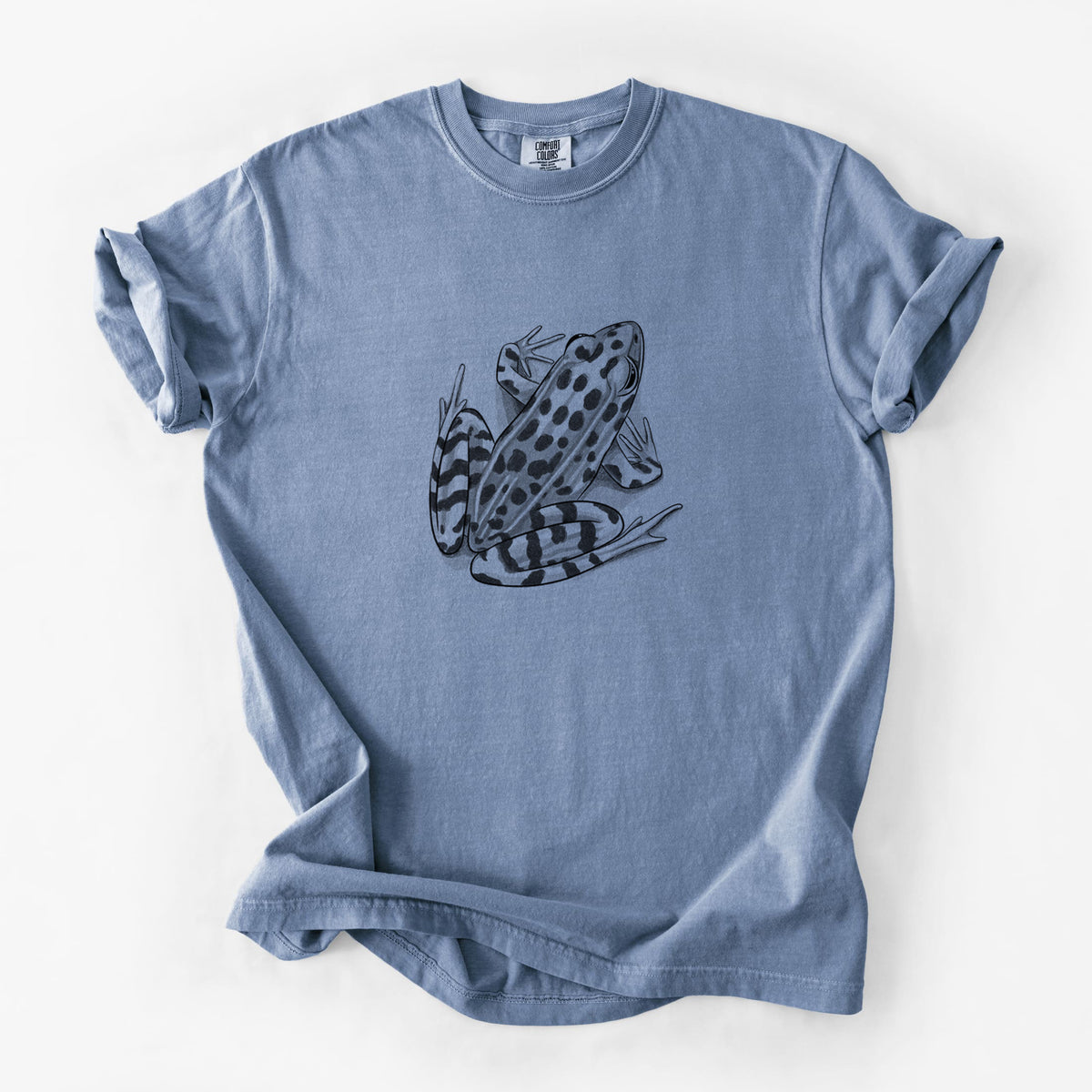 Blue jean Comfort Colors t-shirt laid flat, printed with a detailed black ink illustration of a spotted northern leopard frog.