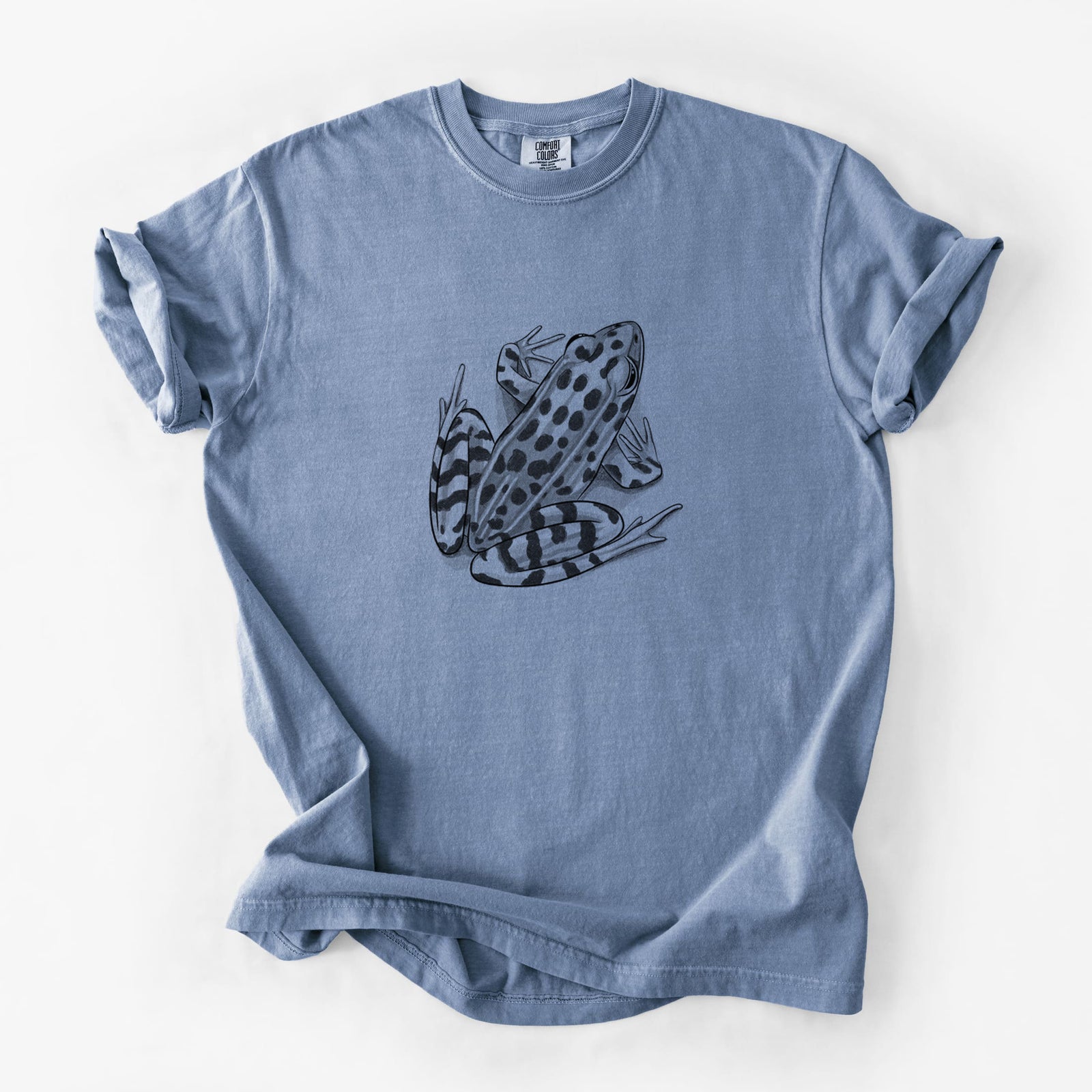 Blue jean Comfort Colors t-shirt laid flat, printed with a detailed black ink illustration of a spotted northern leopard frog.