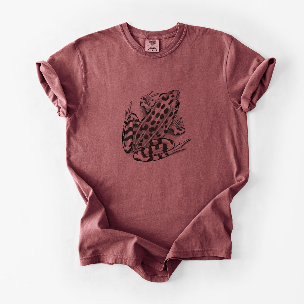 Brick red Comfort Colors t-shirt laid flat, printed with a detailed black ink illustration of a spotted northern leopard frog.