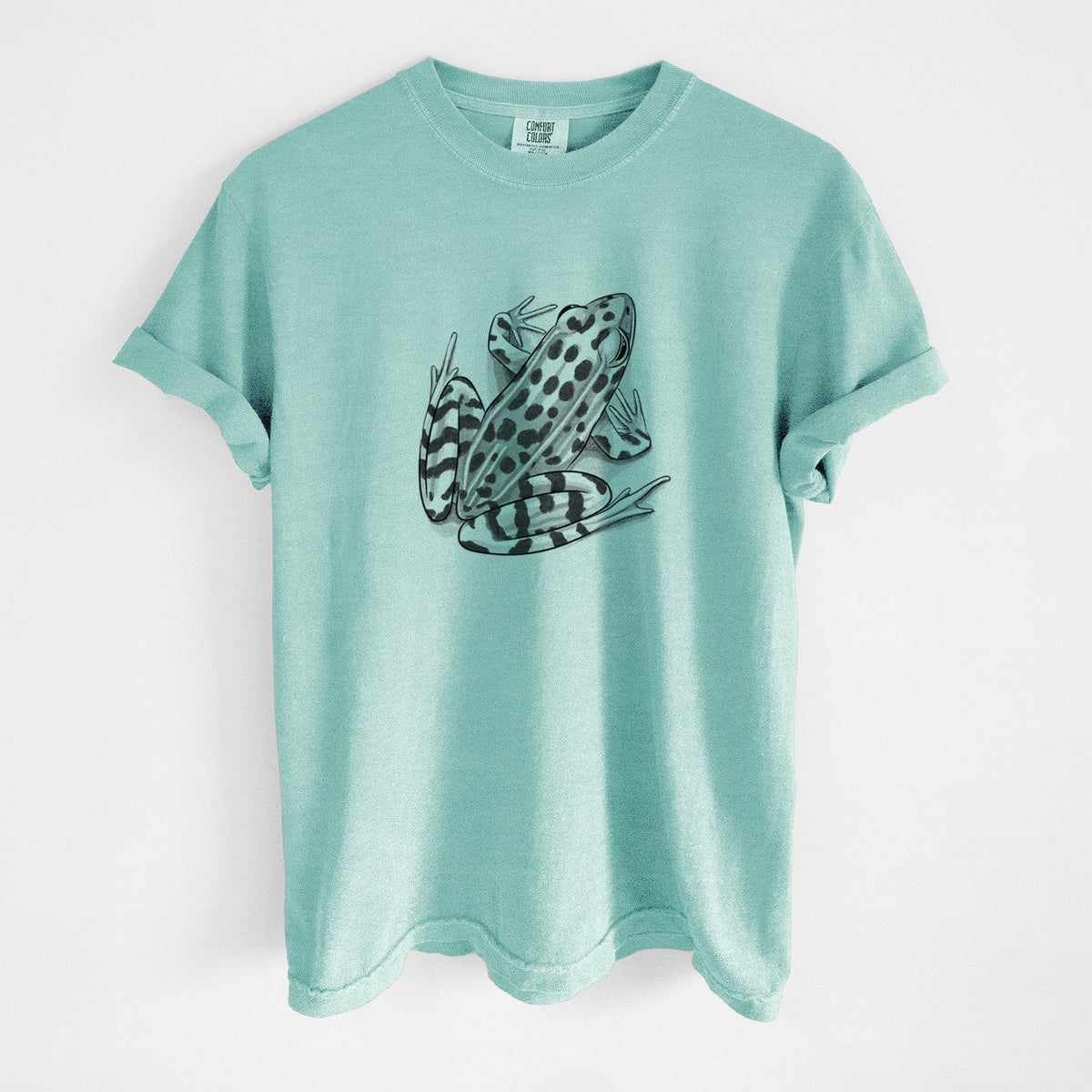 Chalky mint Comfort Colors t-shirt laid flat, printed with a detailed black ink illustration of a spotted northern leopard frog.