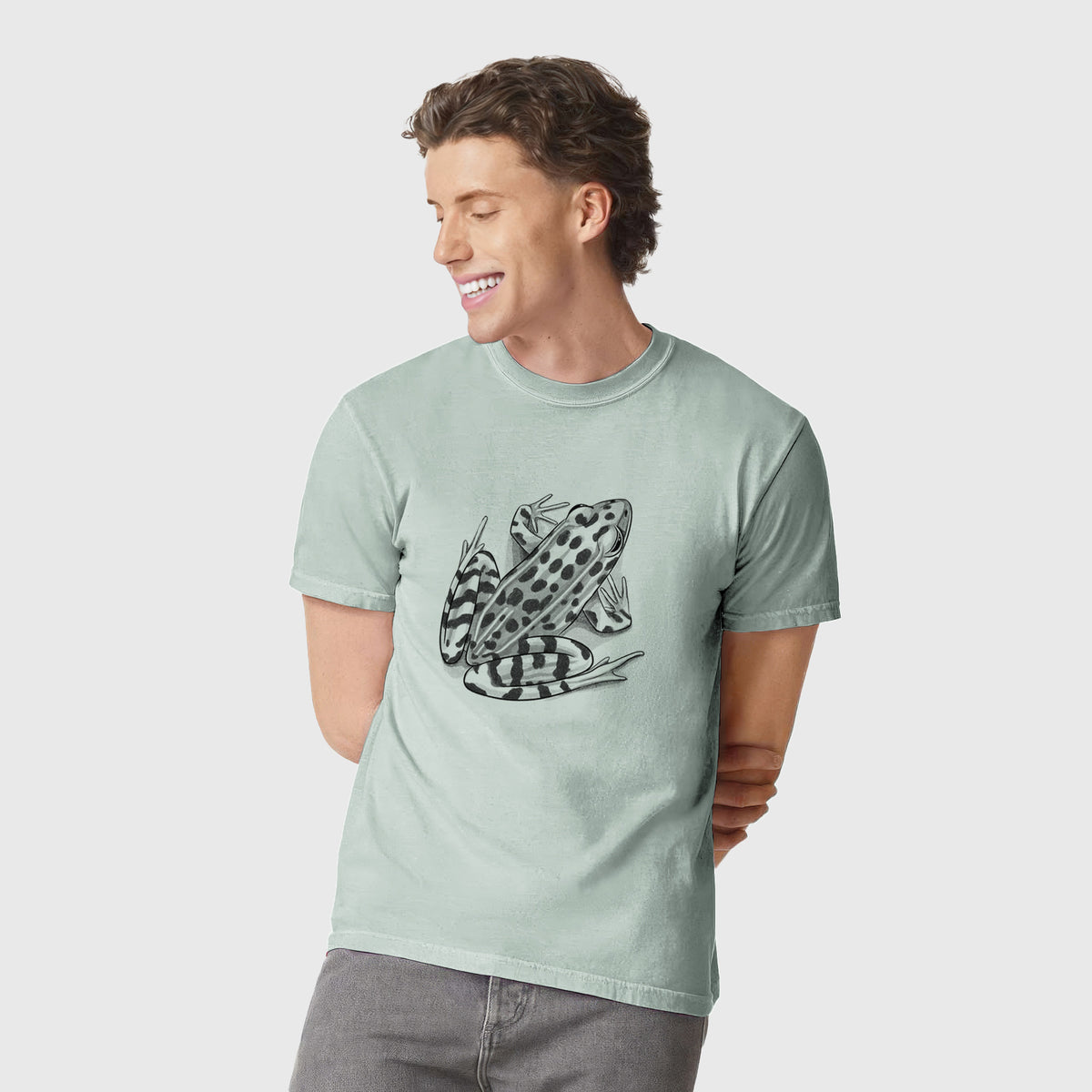Man wearing a Comfort Colors t-shirt printed with a detailed black ink illustration of a spotted northern leopard frog.