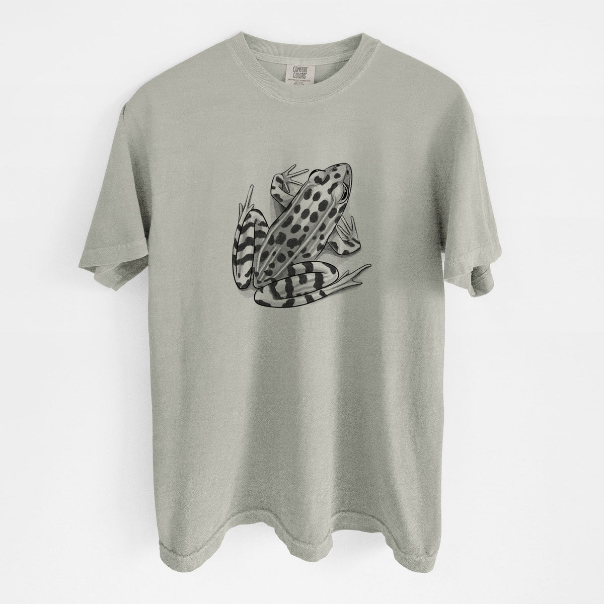 Sandstone beige Comfort Colors t-shirt laid flat, printed with a detailed black ink illustration of a spotted northern leopard frog.