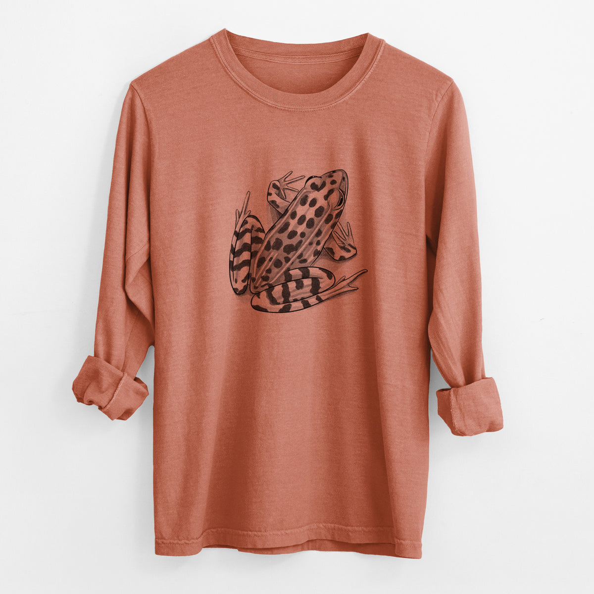 Yam burnt orange Comfort Colors long sleeve shirt laid flat with the cuffs rolled, printed with a detailed black ink illustration of a spotted northern leopard frog.