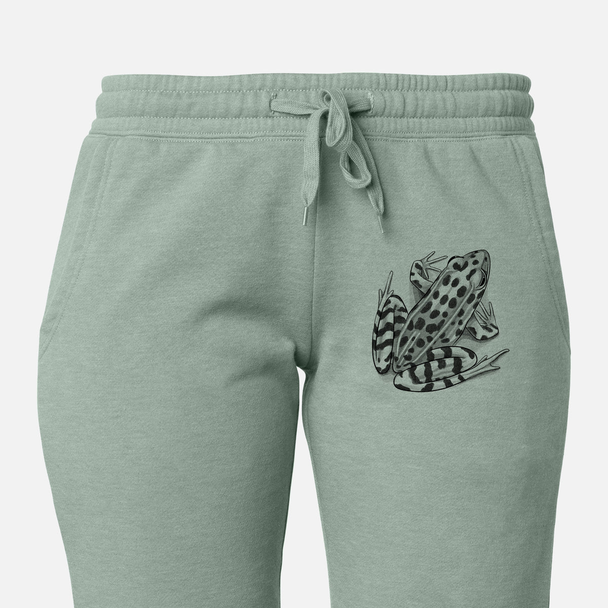 Front of sage green Cali Wave sweatpants, printed with a detailed black ink illustration of a spotted northern leopard frog on the leg.
