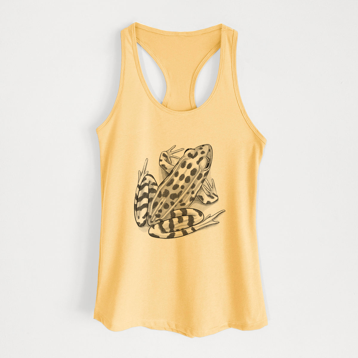 Banana cream women's racerback tank top laid flat, printed with a detailed black ink illustration of a spotted northern leopard frog.