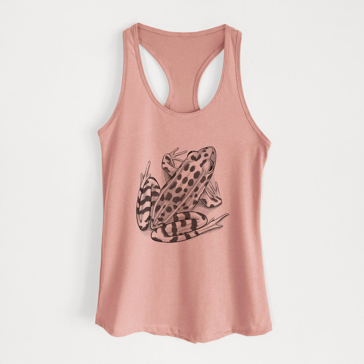 Desert pink women's racerback tank top laid flat, printed with a detailed black ink illustration of a spotted northern leopard frog.