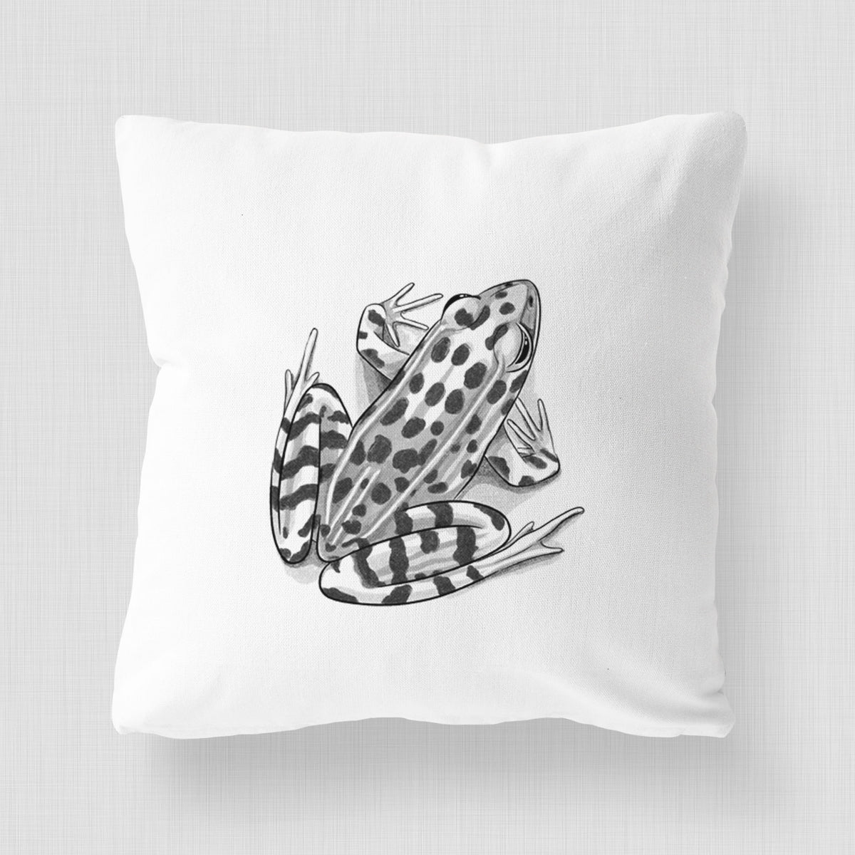 White pillow cover printed with a detailed black ink illustration of a spotted northern leopard frog.