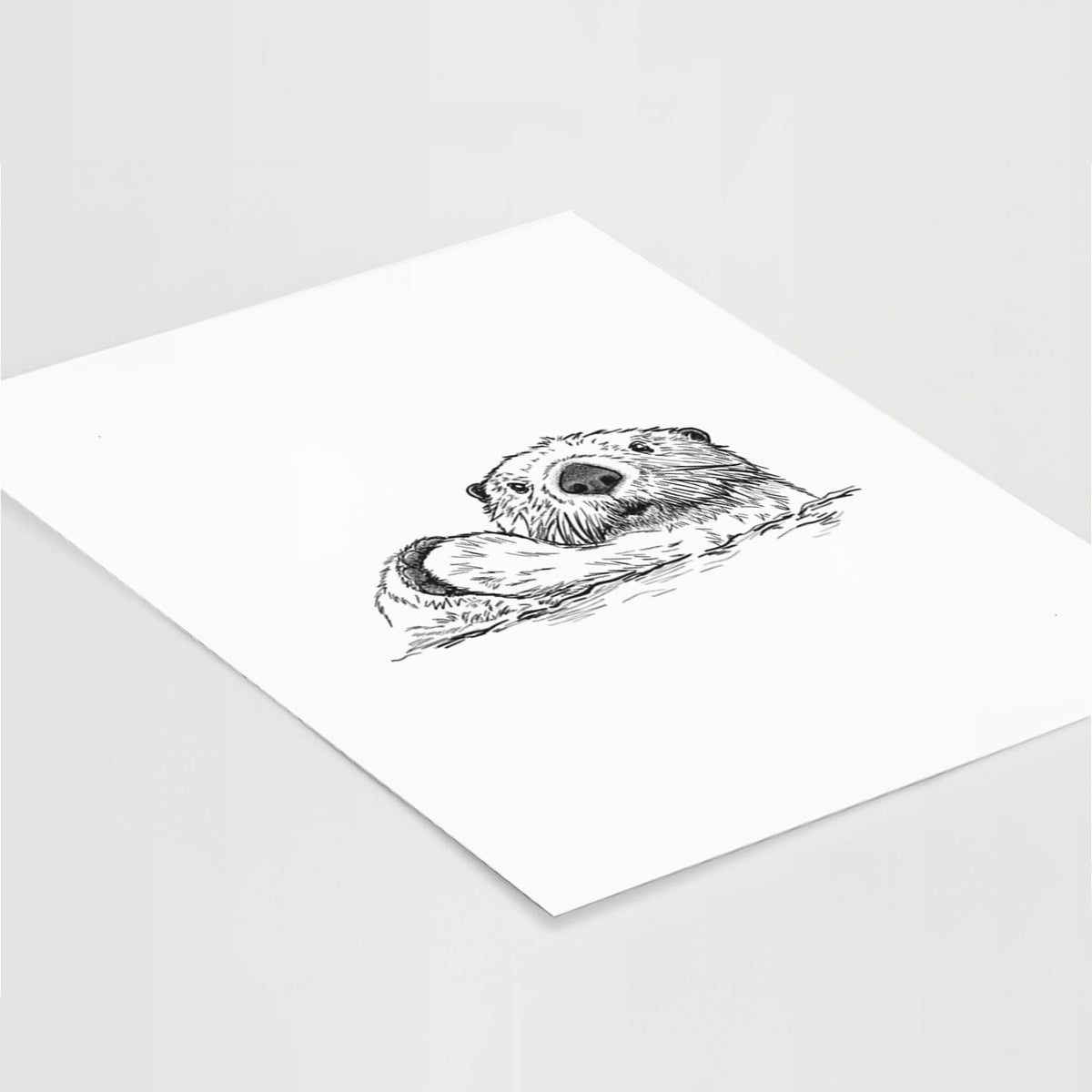 Art print of a black ink illustration of a northern river otter peeking out of the water, lying at an angle on a white surface.