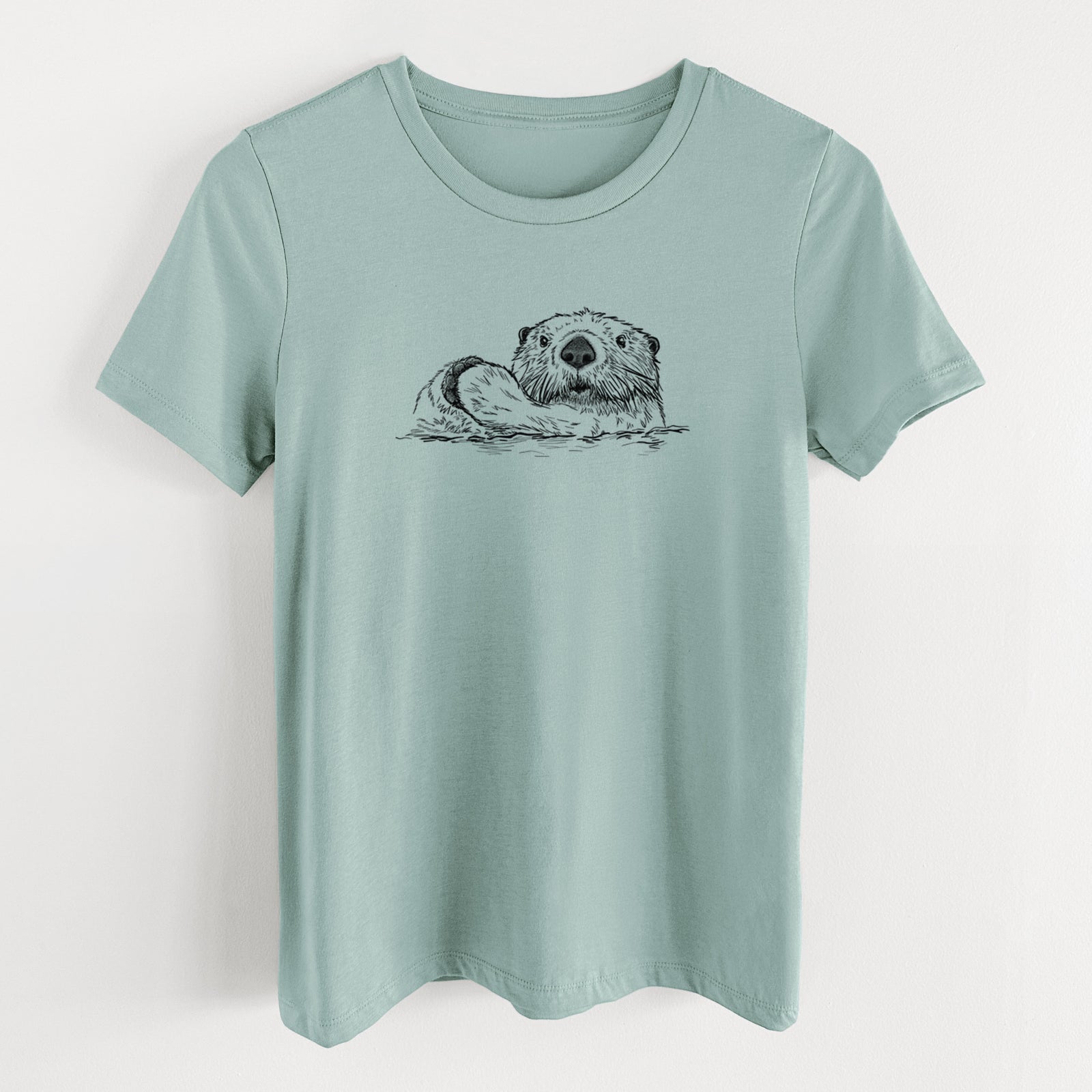 Dusty blue women's relaxed fit cotton t-shirt laid flat, printed with a black ink illustration of a northern river otter peeking out of the water.