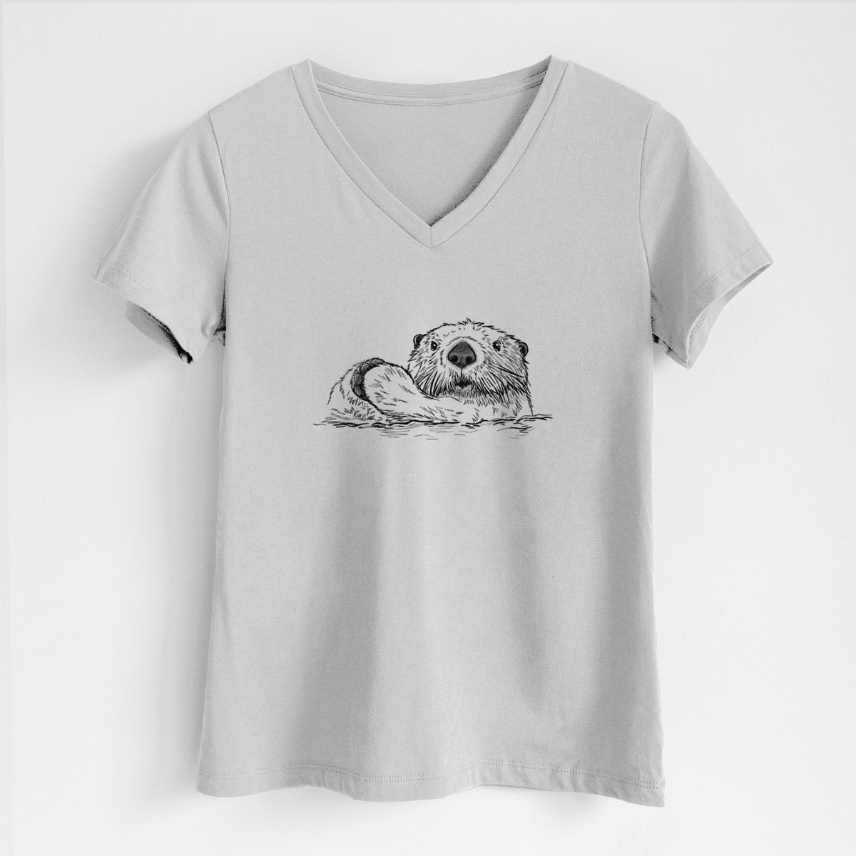 Lunar grey women's relaxed fit cotton V-neck t-shirt laid flat, printed with a black ink illustration of a northern river otter peeking out of the water.