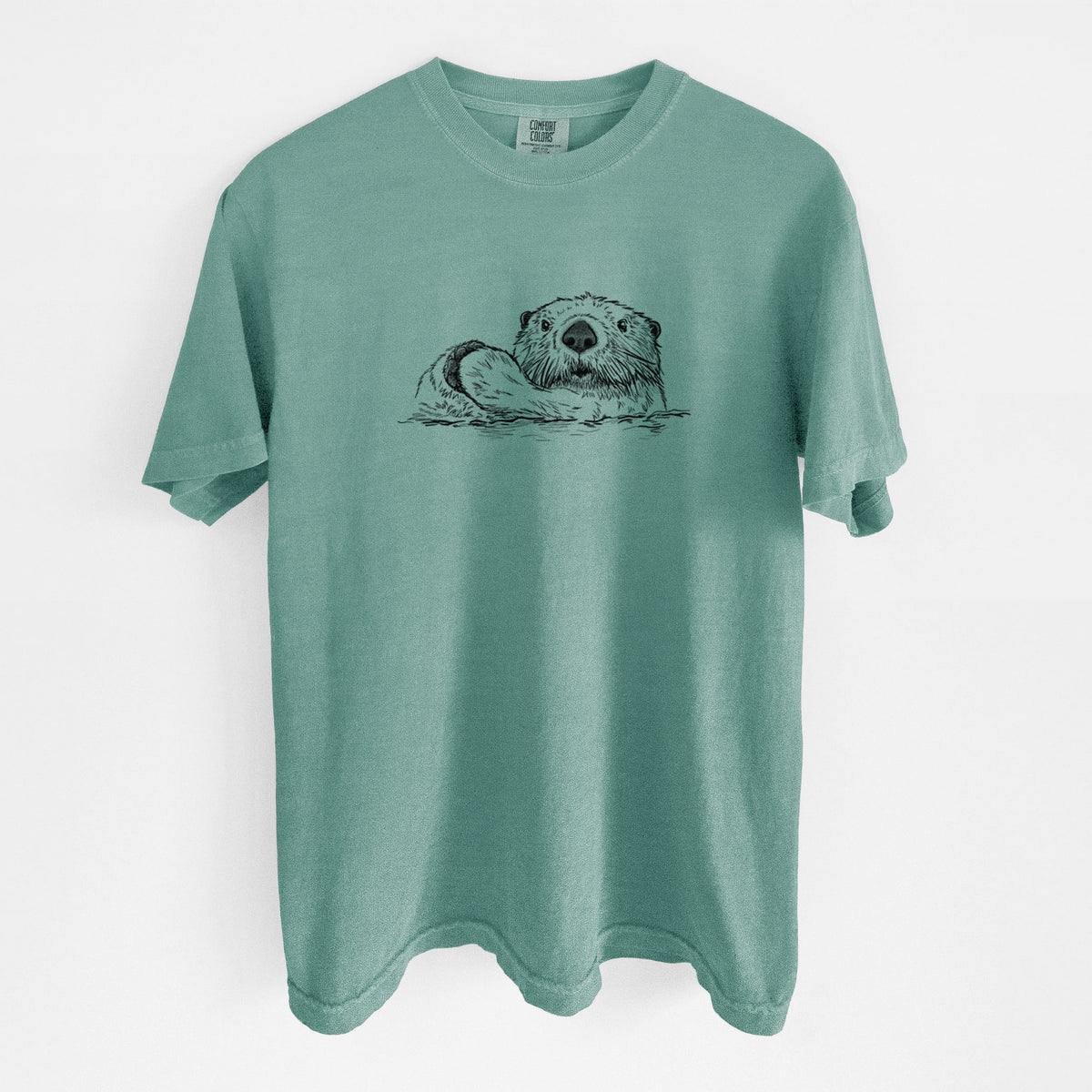 Reef green Comfort Colors t-shirt laid flat, printed with a black ink illustration of a northern river otter peeking out of the water.