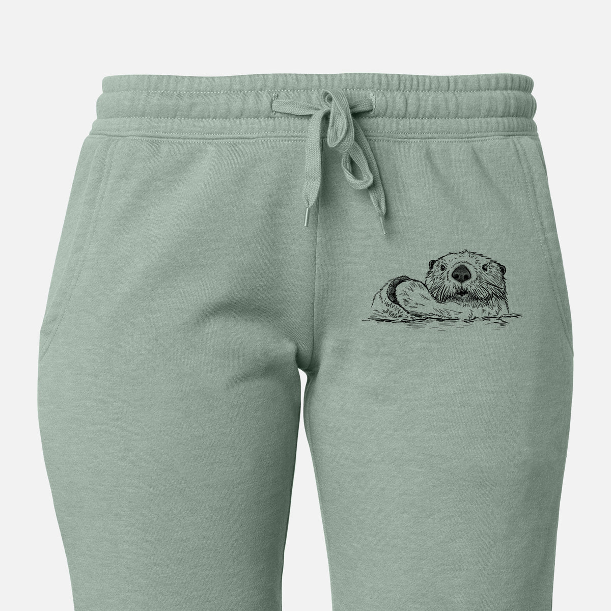 Front of sage green Cali Wave sweatpants, printed with a black ink illustration of a northern river otter peeking out of the water on the leg.