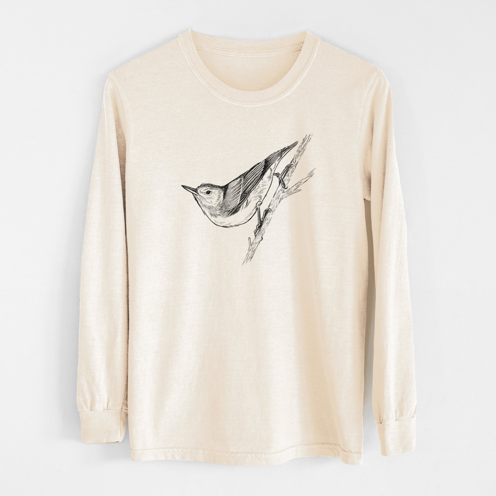 Ivory Comfort Colors long sleeve shirt laid flat, printed with a detailed black ink sketch of a nuthatch clinging to a branch.