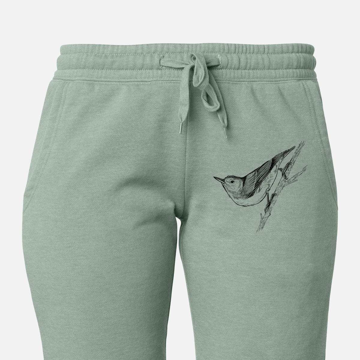 Front of sage green Cali Wave sweatpants, printed with a detailed black ink sketch of a nuthatch clinging to a branch on the leg.
