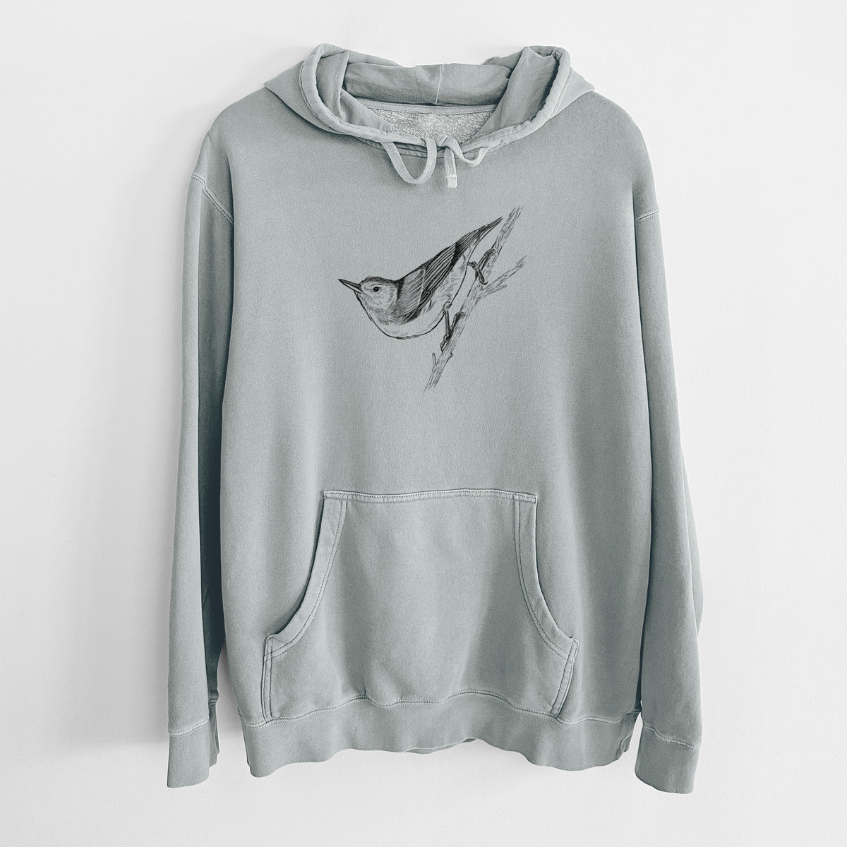 Sage green pigment dyed hoodie laid flat, printed with a detailed black ink sketch of a nuthatch clinging to a branch.