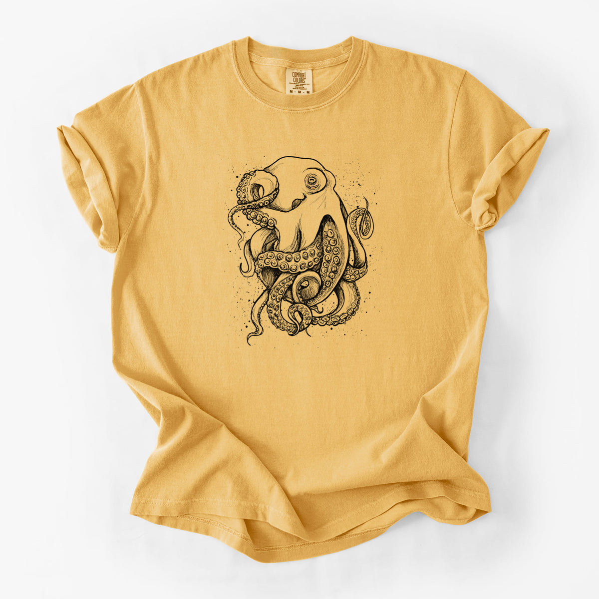 Golden wheat yellow Comfort Colors t-shirt laid flat, printed with a detailed black ink illustration of a common octopus with curling tentacles.