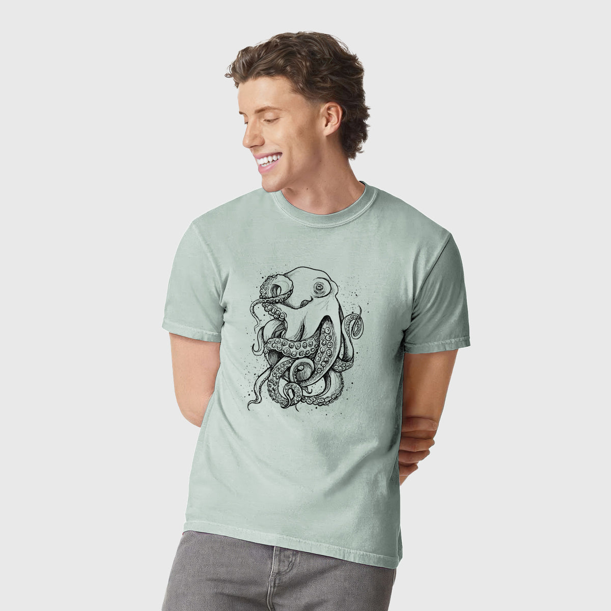 Man wearing a Comfort Colors t-shirt printed with a detailed black ink illustration of a common octopus with curling tentacles.