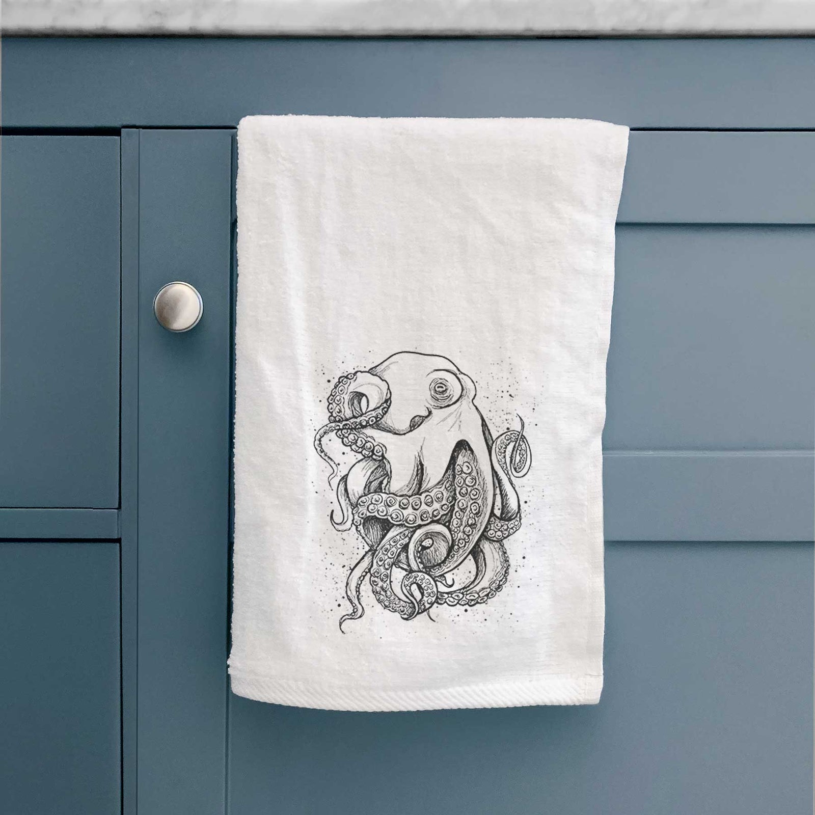 White hand towel printed with a detailed black ink illustration of a common octopus with curling tentacles.