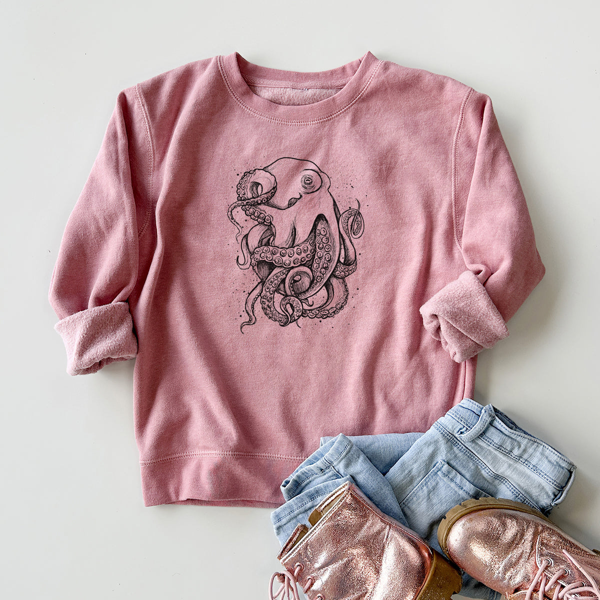 Youth crewneck sweatshirt printed with a detailed black ink illustration of a common octopus with curling tentacles, styled flat with jeans and boots.