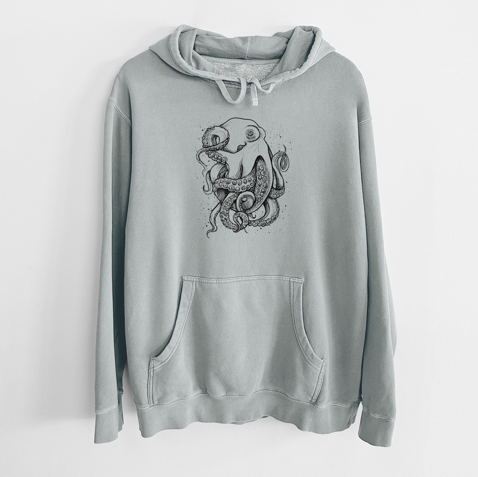 Sage green pigment dyed hoodie laid flat, printed with a detailed black ink illustration of a common octopus with curling tentacles.