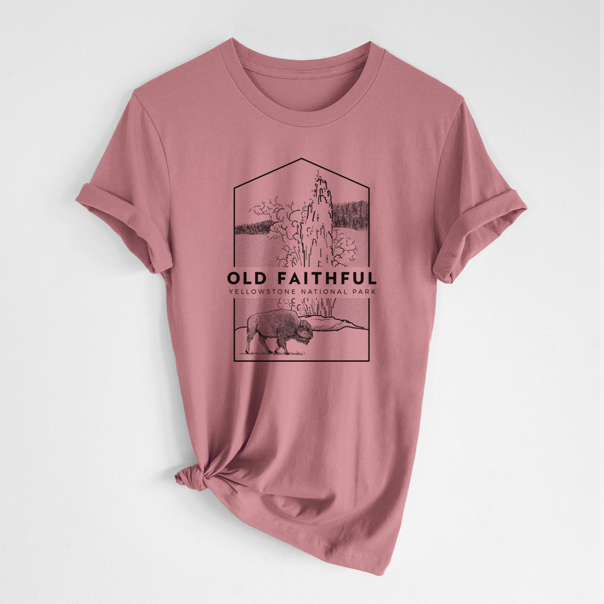 Mauve pink lightweight cotton t-shirt laid flat with the sleeves rolled, printed with a black line art badge of the Old Faithful geyser erupting with a bison nearby, with the words Old Faithful, Yellowstone National Park.